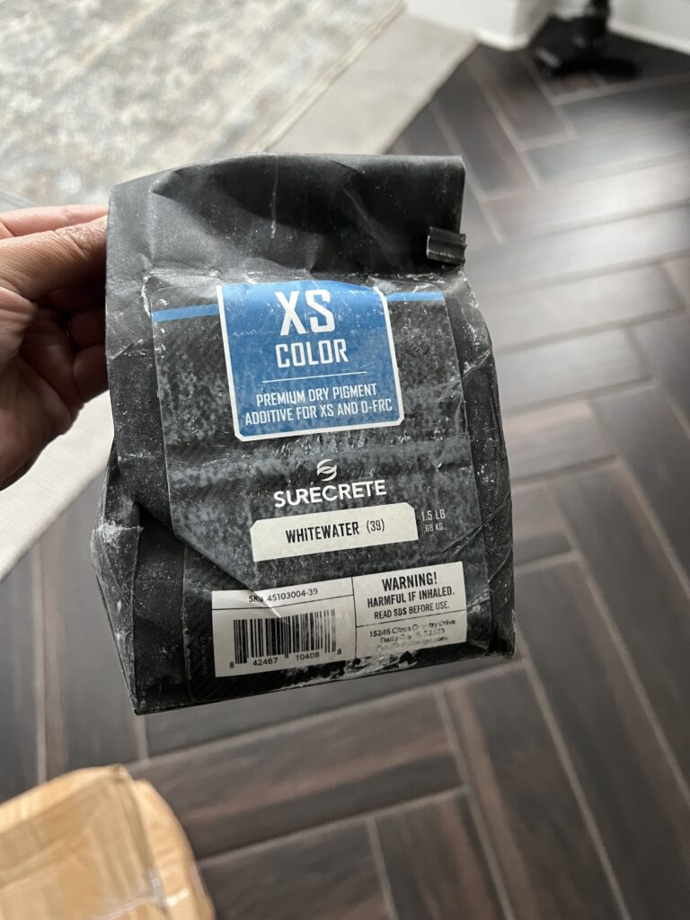 Bag of Surecrete XS Color Pigment in Whitewater used to tint microcement for a DIY project.