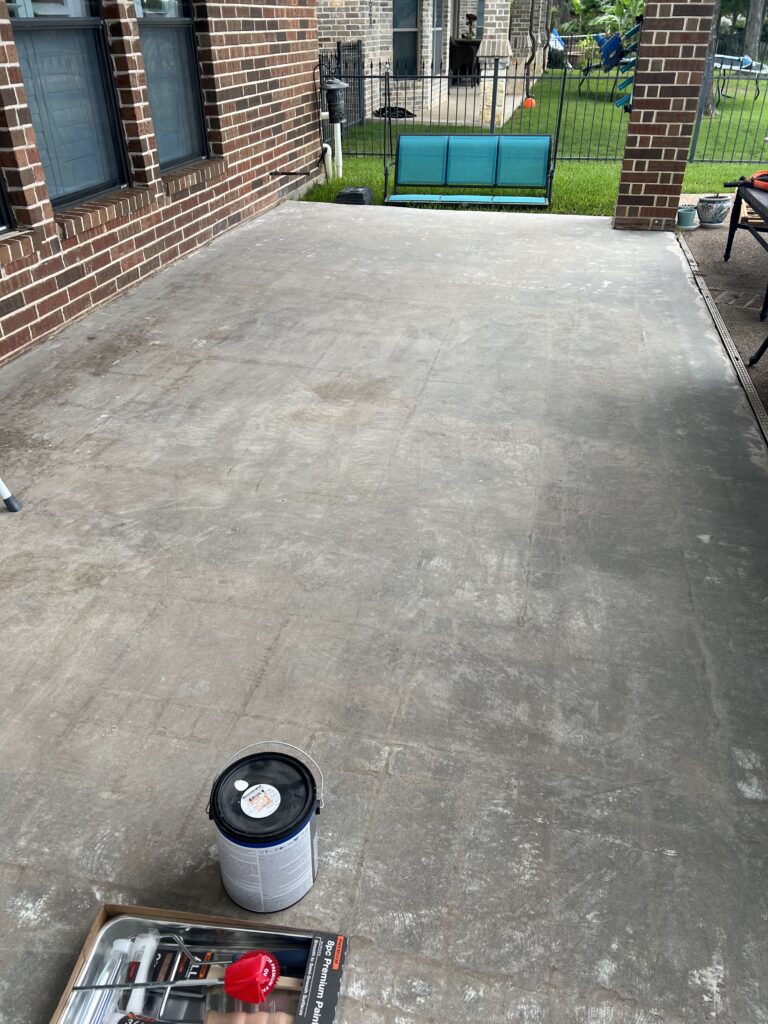 Prepped concrete patio surface showing scraped texture before applying the base coat.