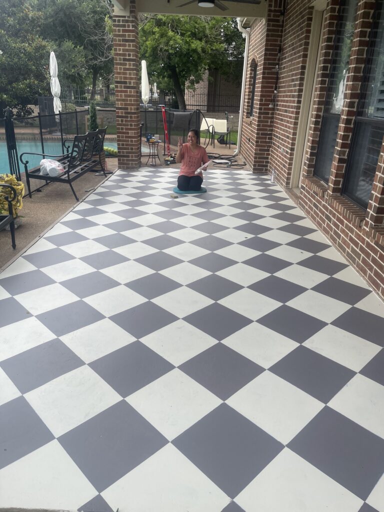 Finished checkered patio floor in off-white and gray with Adriana sitting in the center.