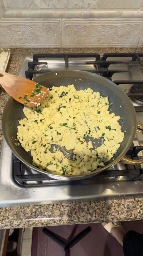 Seasoned tofu scramble cooking in a pan for a vegan breakfast burrito