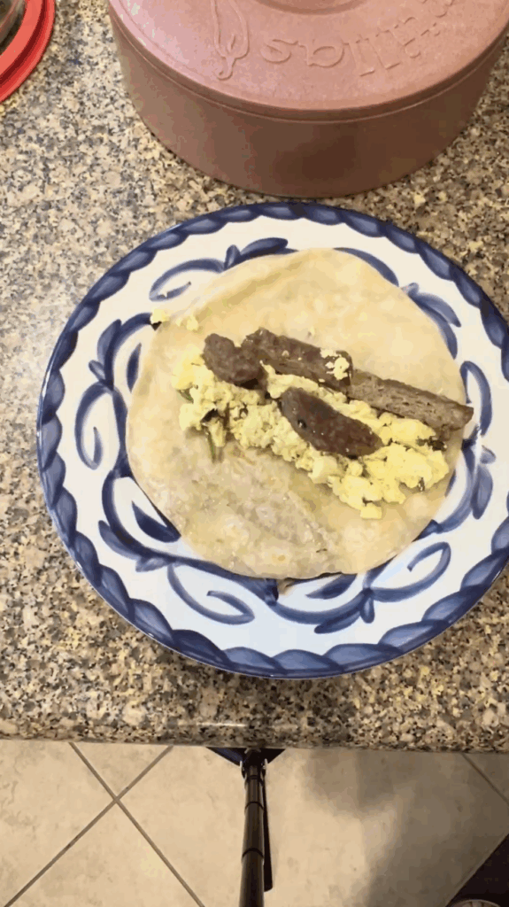 Vegan breakfast burrito with tofu scramble and plant-based sausage on a flour tortilla